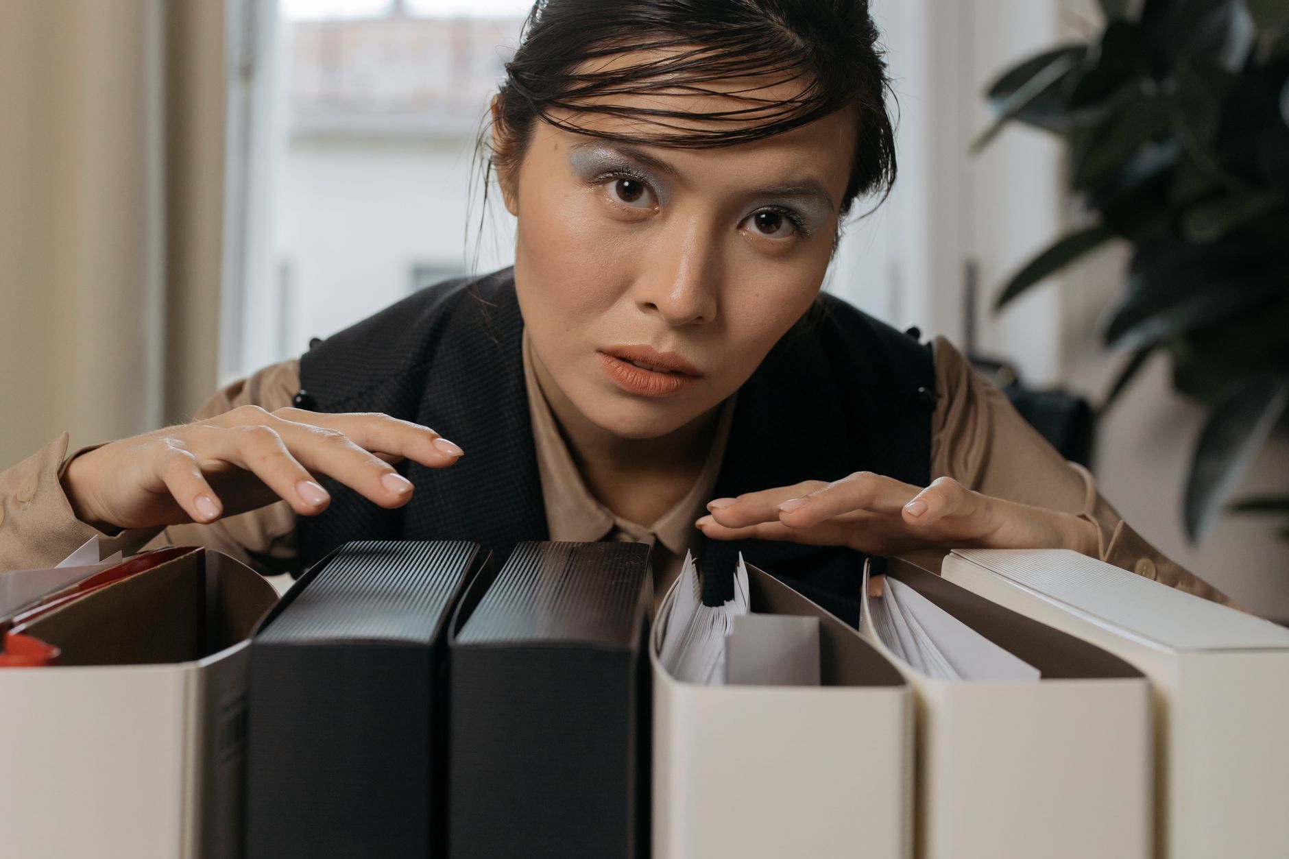 Filed business records in folders on a shelf.