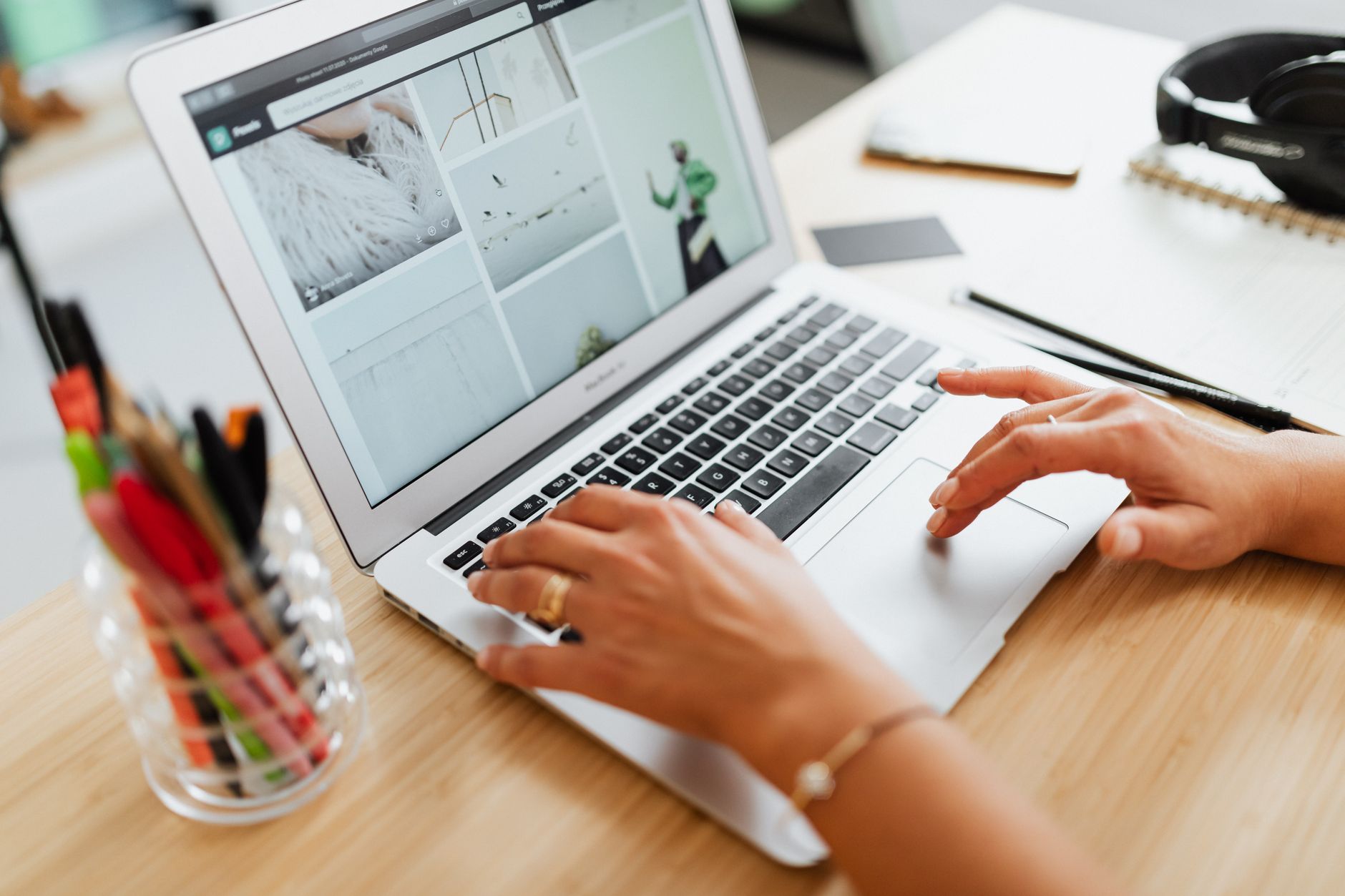A person's hands at a laptop, searching a members' register.