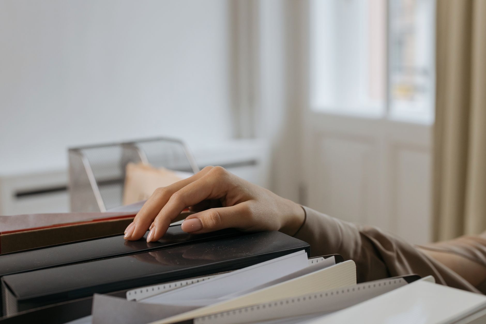 Document folders and papers sorted on an office desk