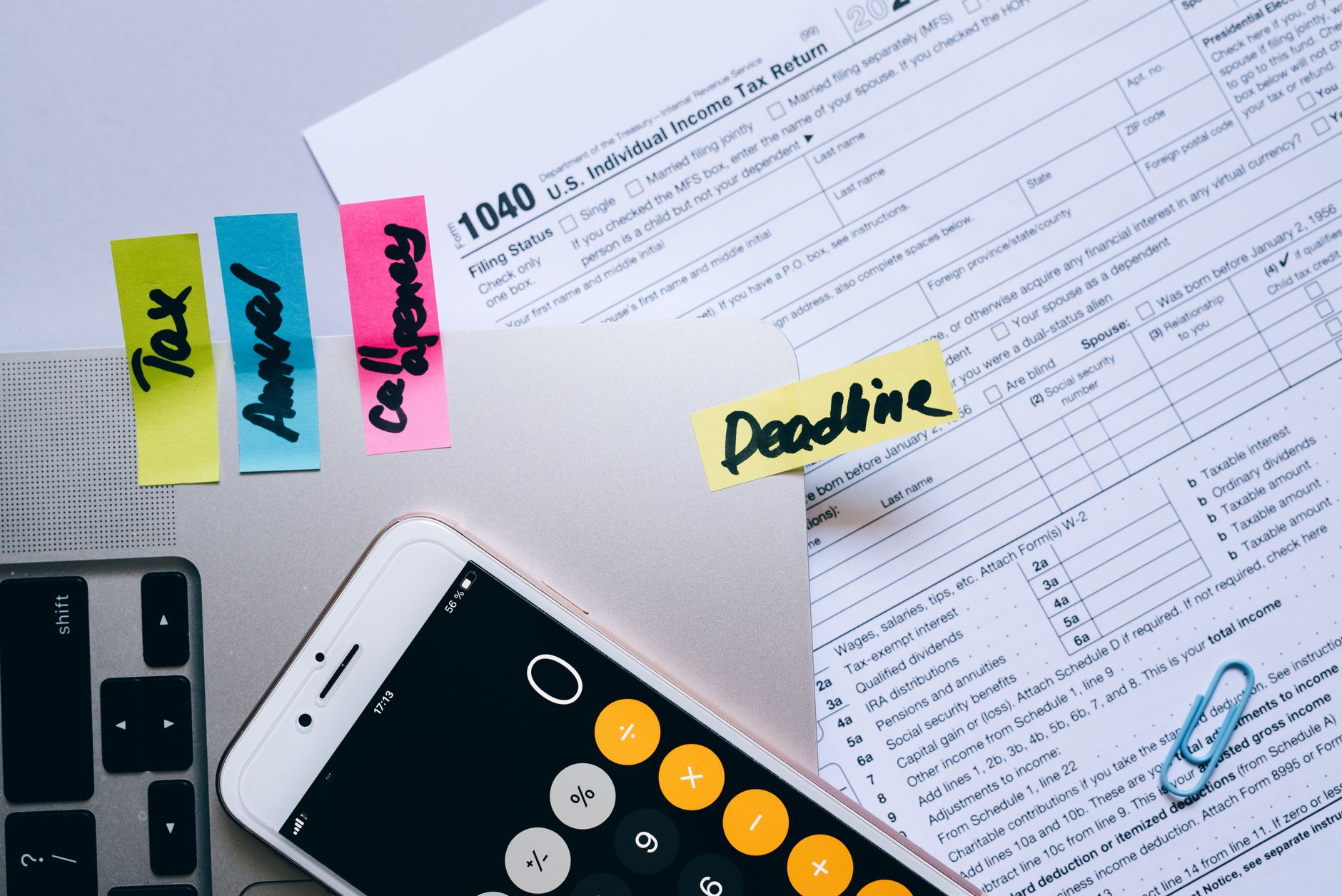 A calculator and a notebook on a desk.