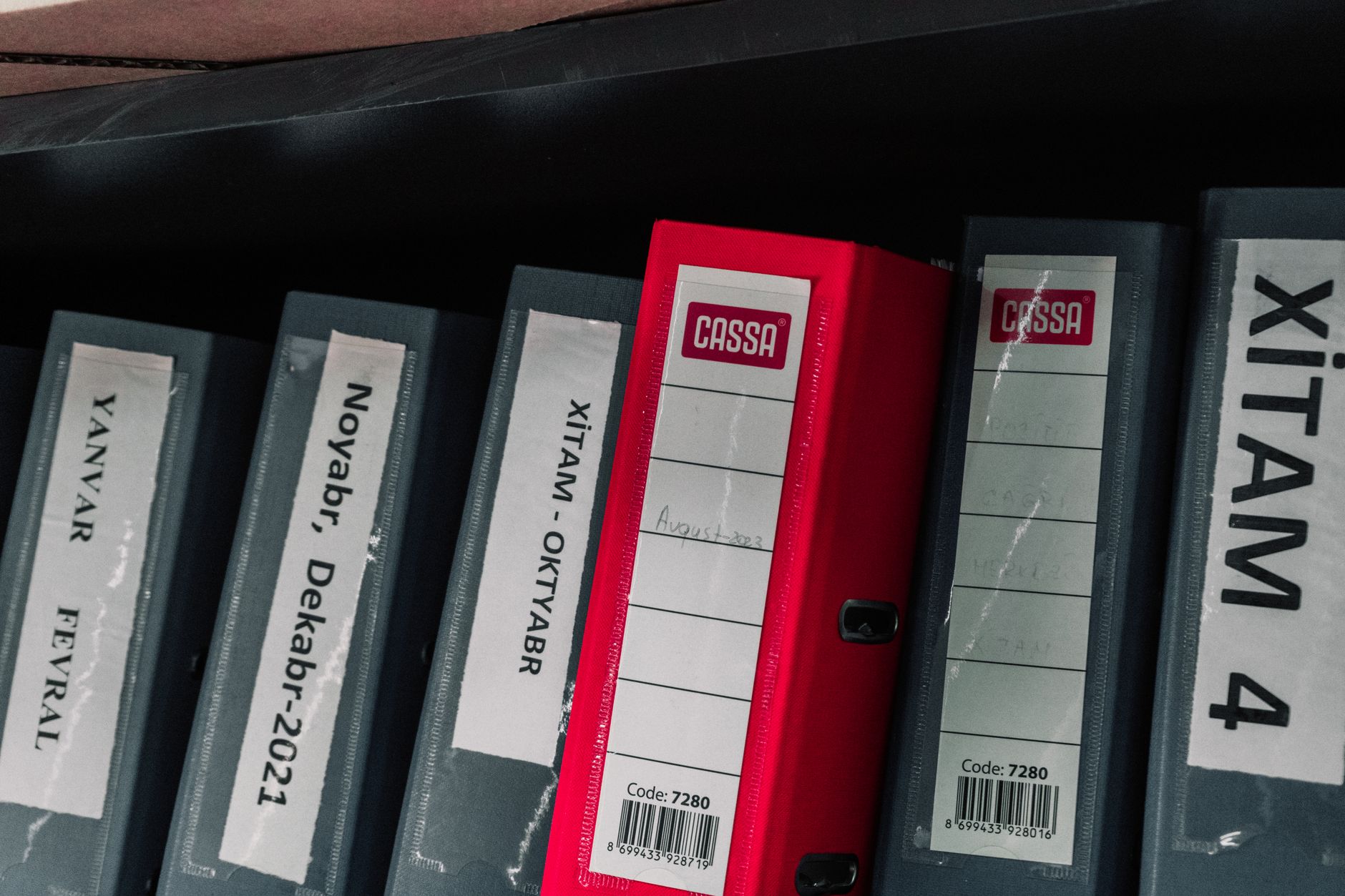 Tabbed document folders on an office shelf