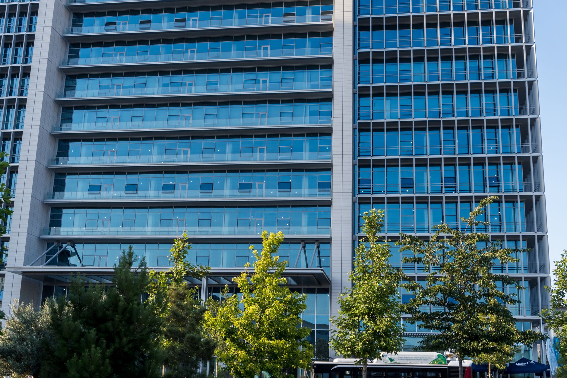 Glass office buildings in a business district in daylight.