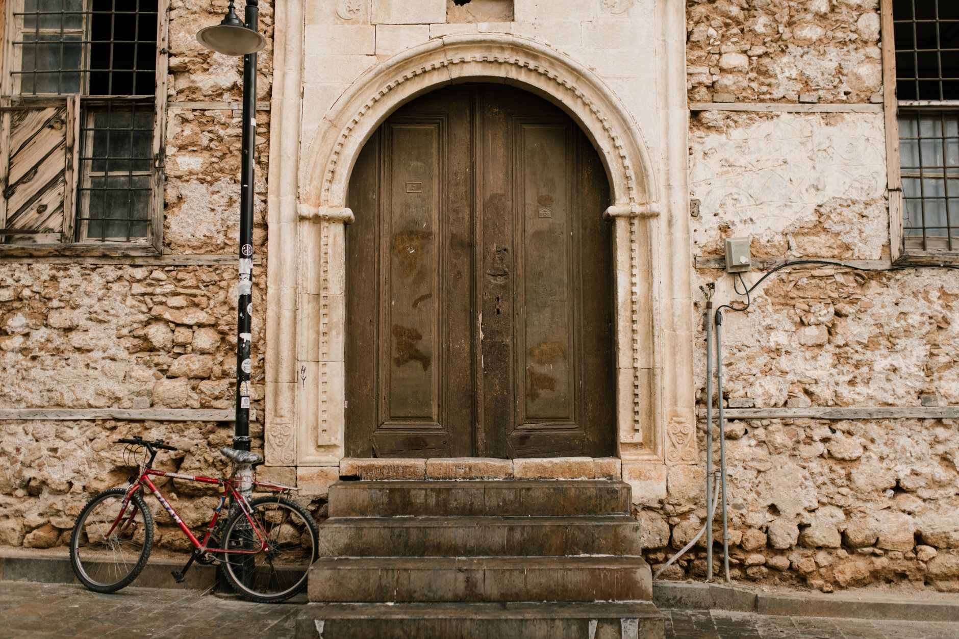 A wooden doorway in a building on a quiet city street.