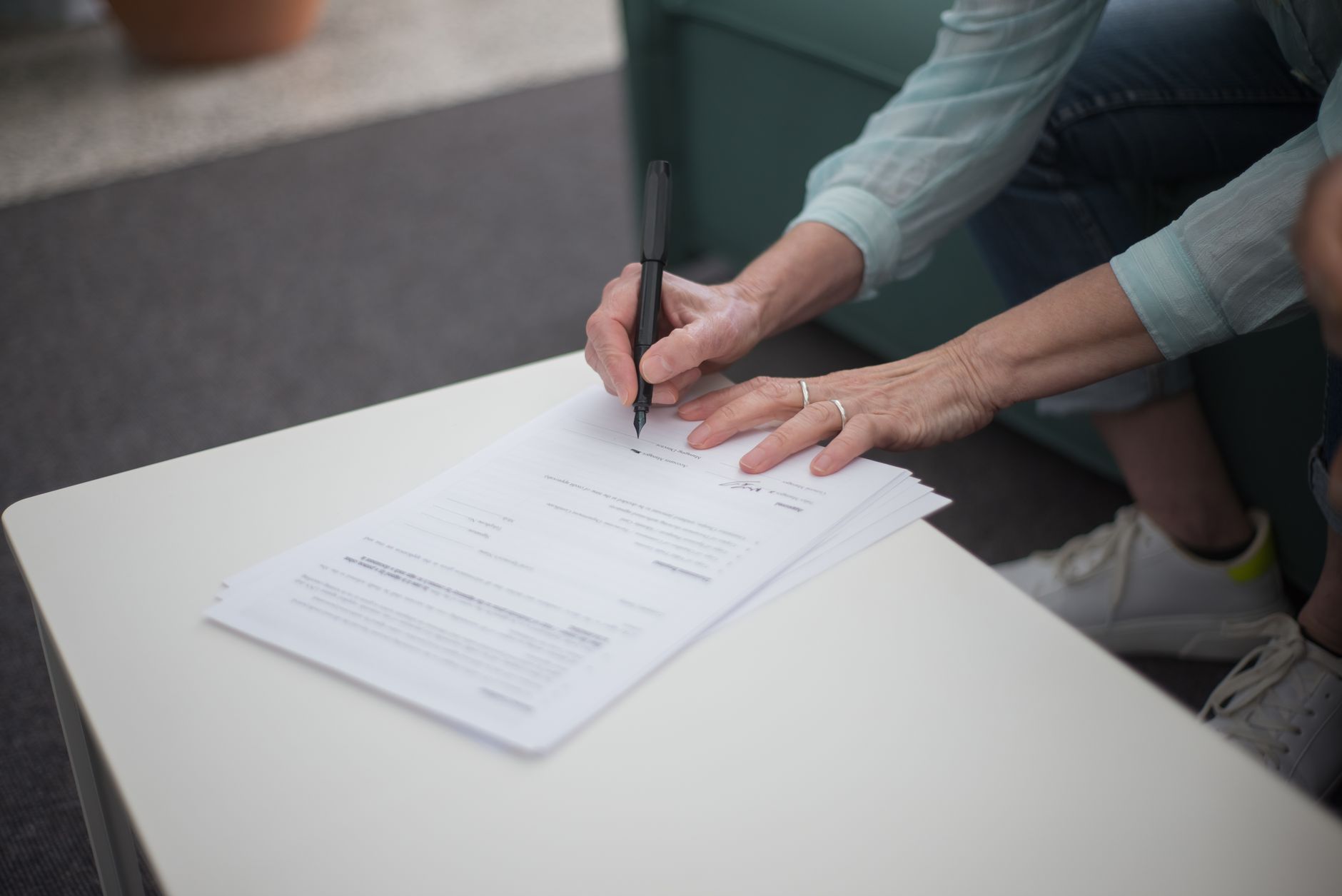 A passport and a folder of business documents on a desk.